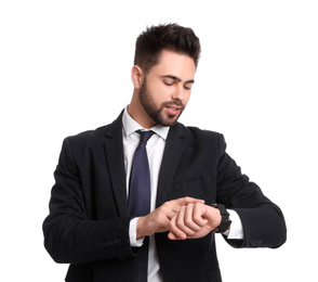 Photo of Young businessman checking time on white background