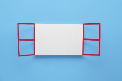 Photo of Open paper window frame on light blue background. Space for text