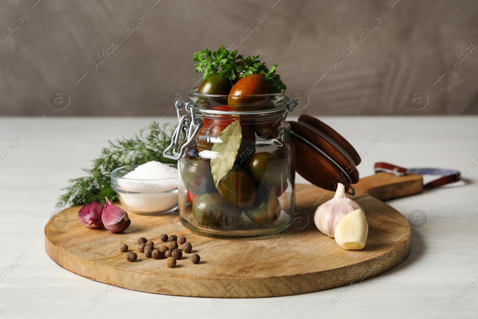 Photo of Pickling jar with fresh ripe tomatoes on white table