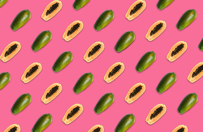 Pattern of whole and halved papaya fruits on pink background