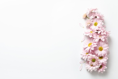 Photo of Beautiful chamomile flowers on white background, flat lay with space for text