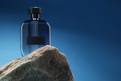 Stylish presentation of luxury men`s perfume on stone against light blue background. Space for text