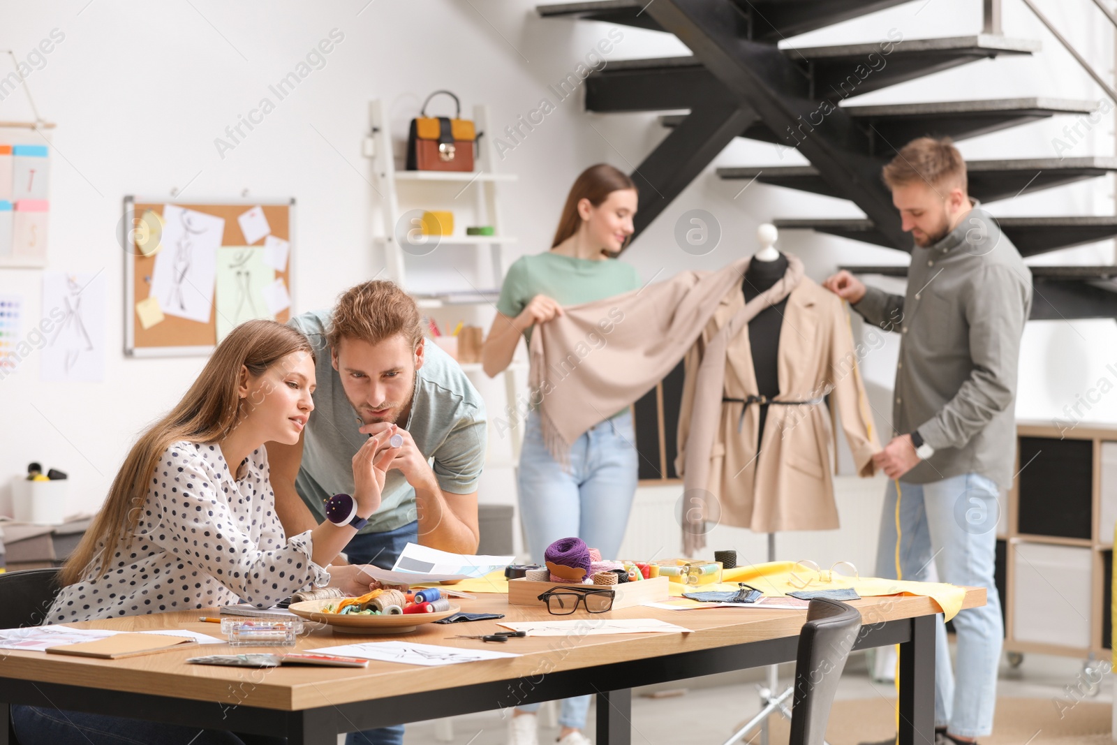 Photo of Fashion designers creating new clothes in studio