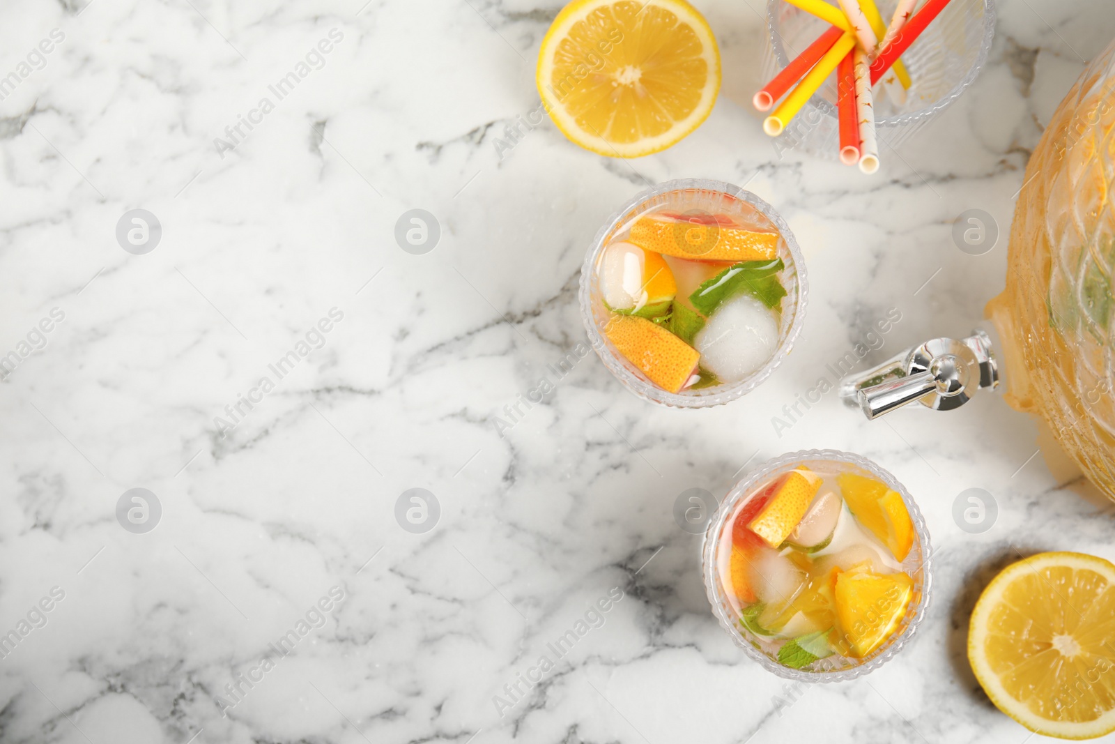 Photo of Delicious refreshing drink with orange and grapefruit on white marble table, flat lay. Space for text