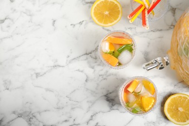 Photo of Delicious refreshing drink with orange and grapefruit on white marble table, flat lay. Space for text