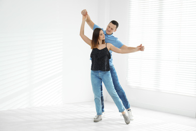 Photo of Beautiful young couple dancing in empty studio