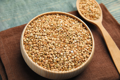 Photo of Uncooked green buckwheat grains on table, closeup