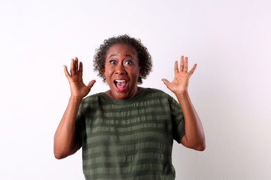 Portrait of happy African-American woman on white background