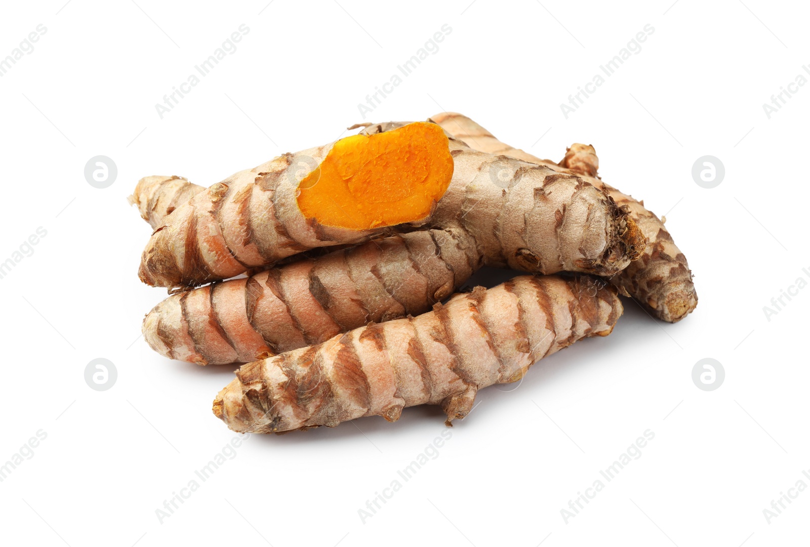 Photo of Whole and cut turmeric roots isolated on white