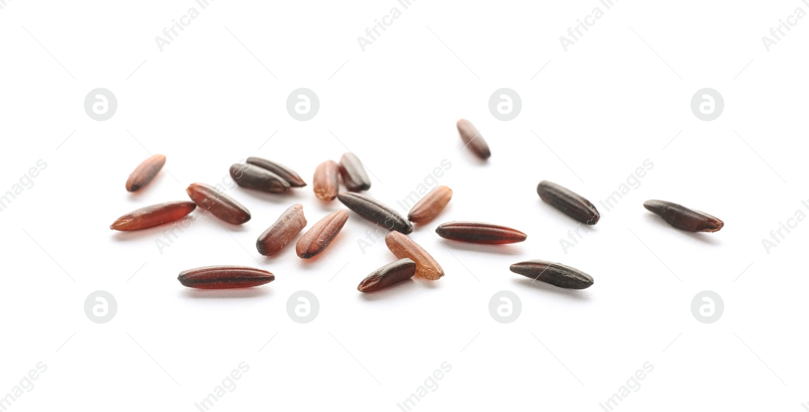 Photo of Scattered grains of brown rice on white background