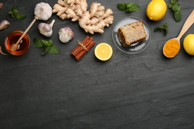 Photo of Flat lay composition with fresh products on black table, space for text. Natural antibiotics