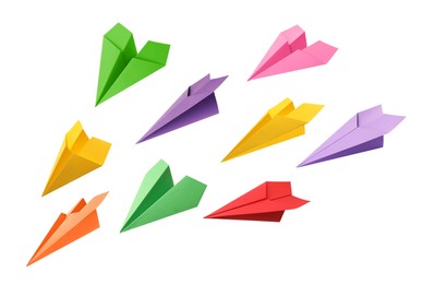 Image of Set with handmade different color paper planes on white background