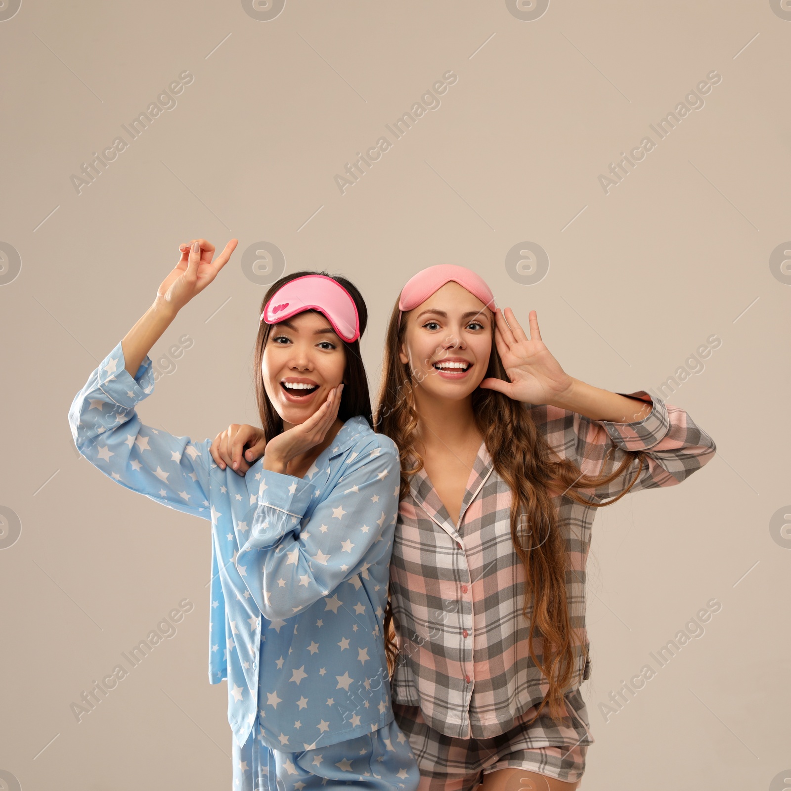 Photo of Beautiful women in pajamas on beige background. Bedtime
