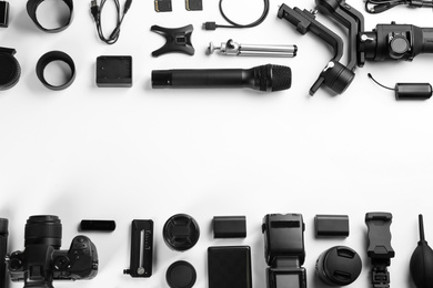 Photo of Composition with camera and video production equipment on white background, top view with space for text