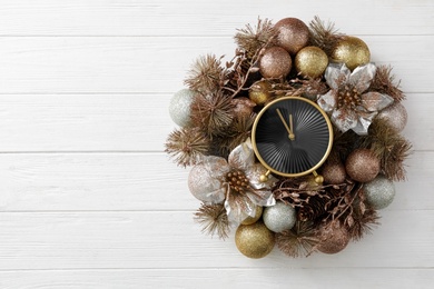 Photo of Top view of stylish clock and Christmas decor on white wooden background, space for text. New Year countdown