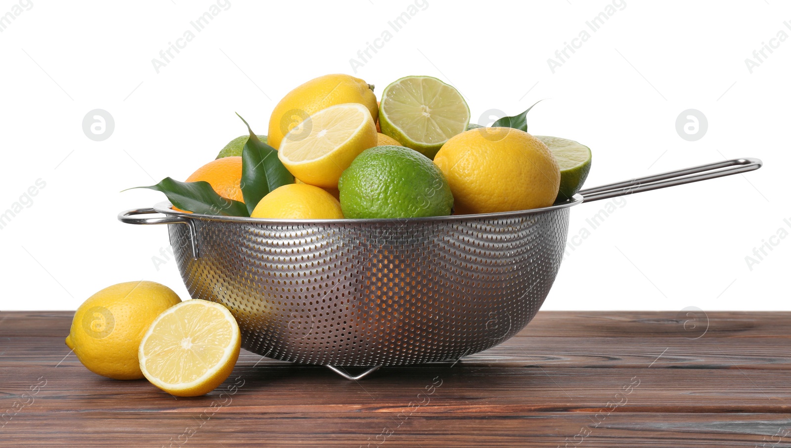 Photo of Metal colander with citrus fruits on wooden table against white background