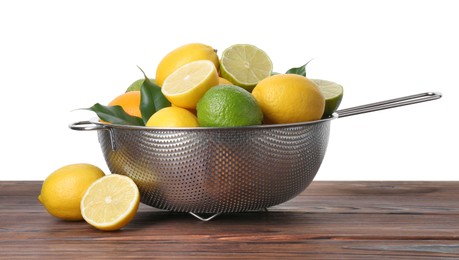 Metal colander with citrus fruits on wooden table against white background