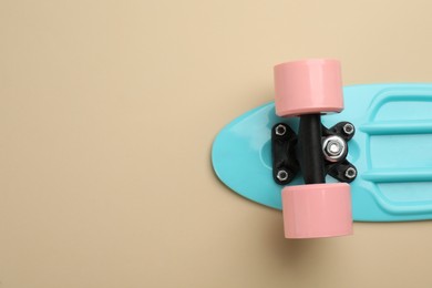 Photo of Skateboard on beige background, top view. Space for text