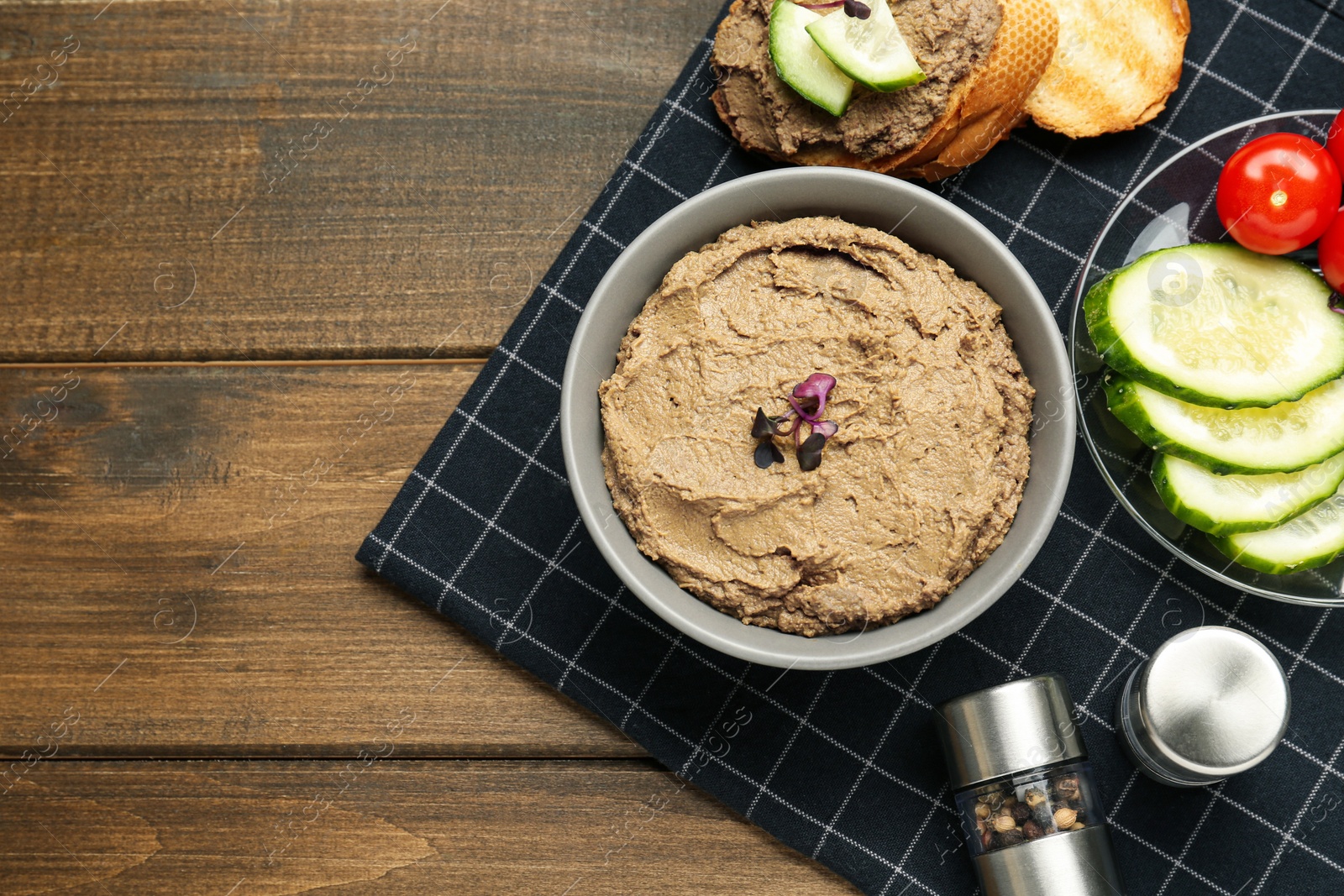 Photo of Delicious liver pate on wooden table, top view. Space for text