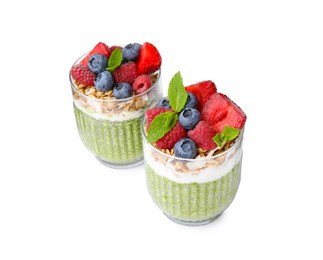 Photo of Tasty matcha chia pudding with oatmeal and berries on white background. Healthy breakfast