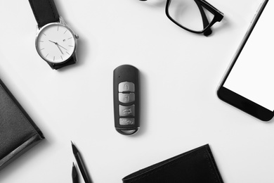 Flat lay composition with male accessories and remote car key on white background. Space for text