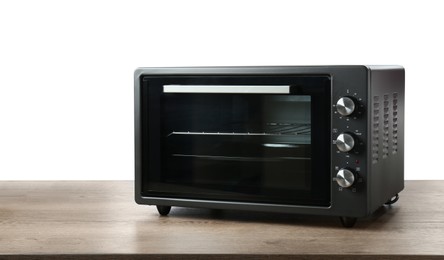 One electric oven on wooden table against white background
