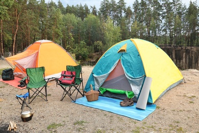 Camping tents and accessories in wilderness on summer day