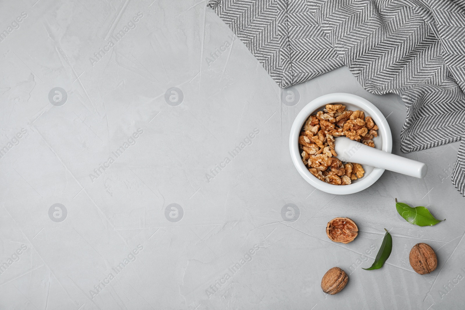 Photo of Flat lay composition with walnuts and space for text on grey background