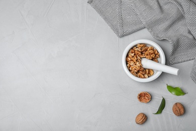 Flat lay composition with walnuts and space for text on grey background