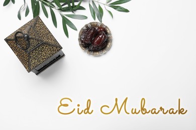 Image of Eid Mubarak greeting card. Arabic lantern and dates on white table, flat lay