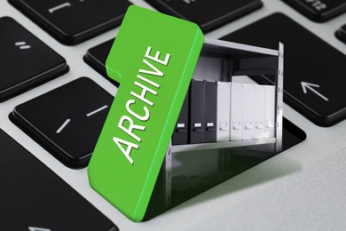 Image of Digital archive. Rack with folders under open green button on computer keyboard