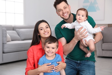 Portrait of happy parents and their cute children at home. Family time