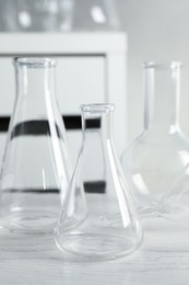 Photo of Set of laboratory glassware on white table indoors