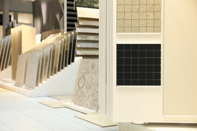 Photo of Assortment of tiles in store. Many different samples indoors