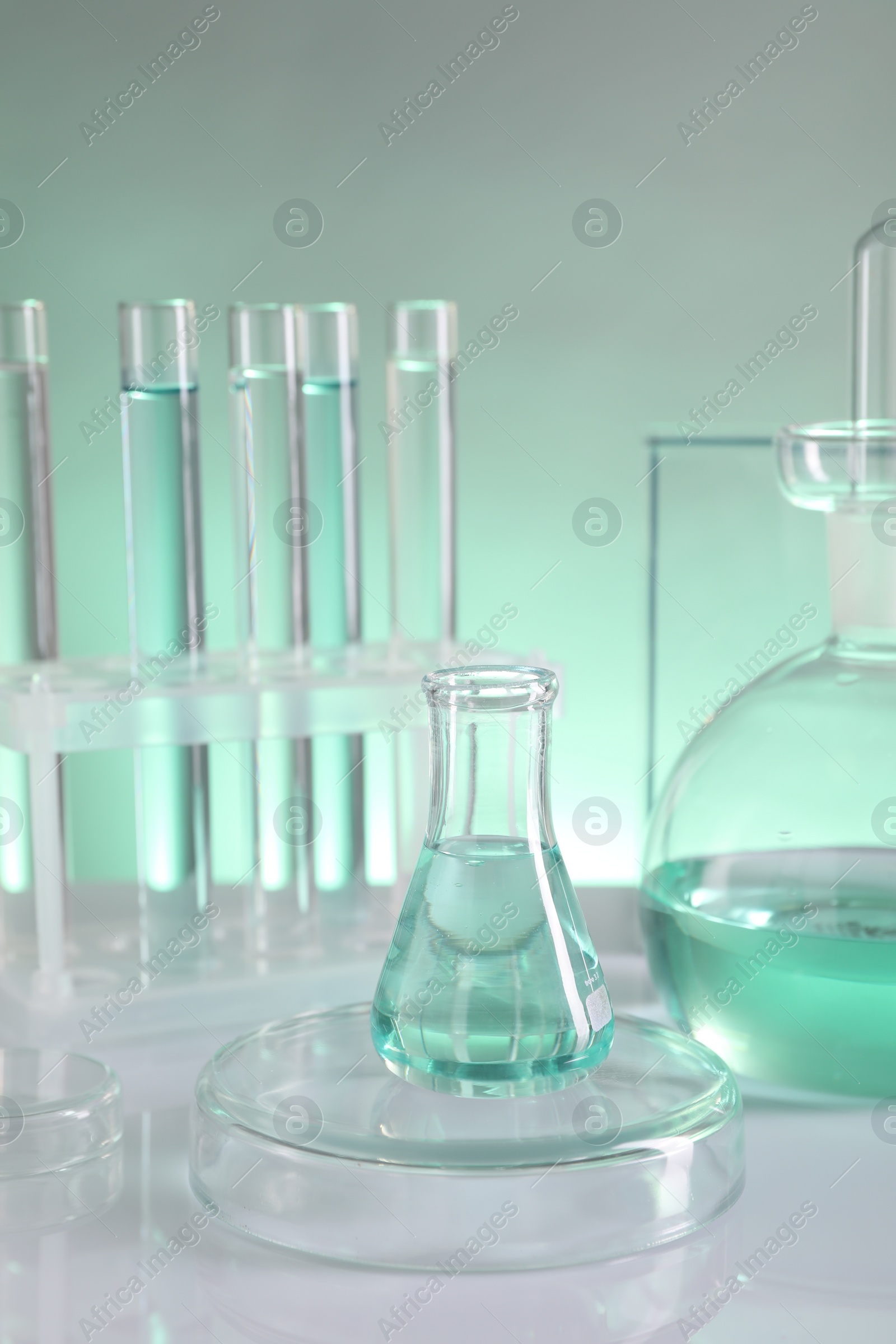 Photo of Laboratory analysis. Different glassware on table against color background