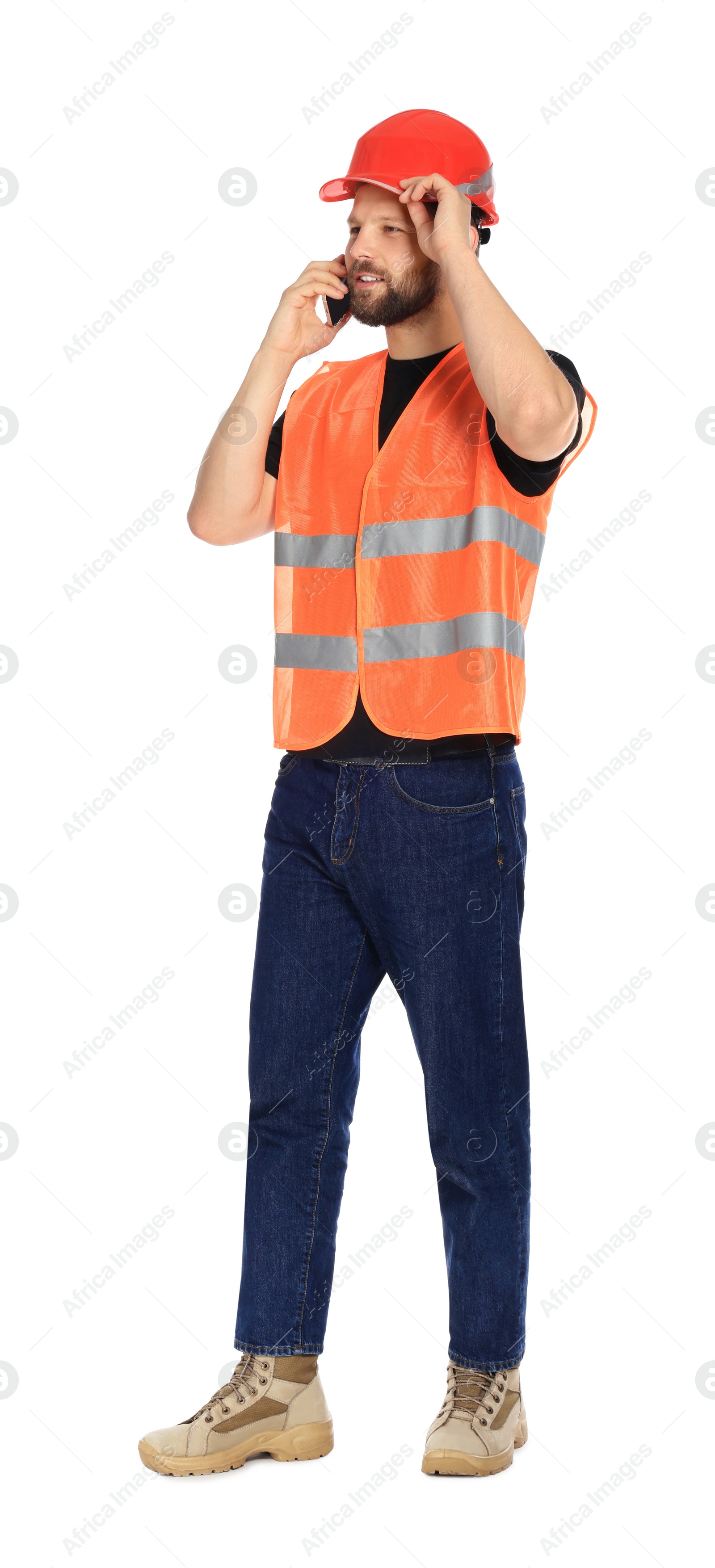 Photo of Man in reflective uniform talking on smartphone against white background