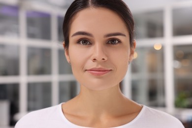 Portrait of beautiful young woman on blurred background