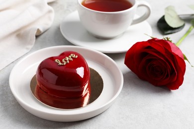Photo of St. Valentine's Day. Delicious heart shaped cake served on light table, closeup