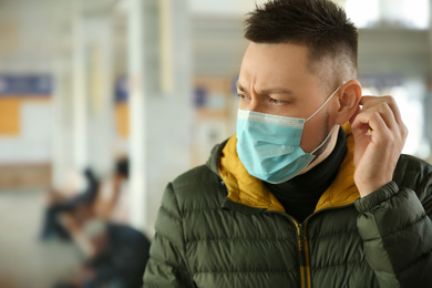 Photo of Man with disposable mask indoors. Virus protection