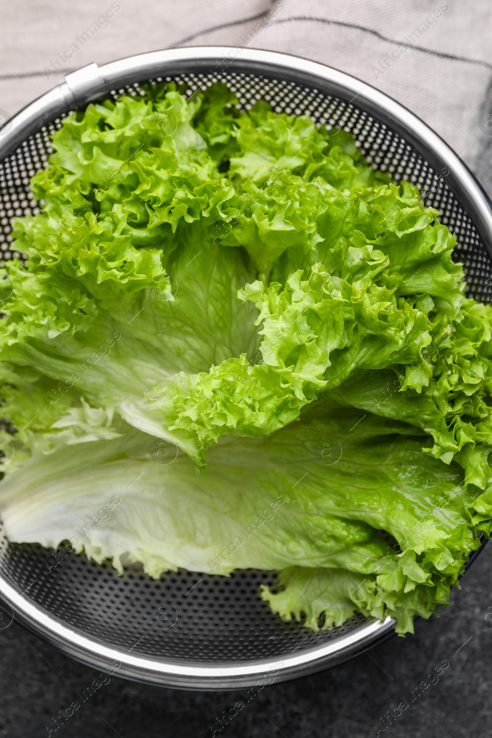 Photo of Fresh lettuce on stone table, top view. Salad greens