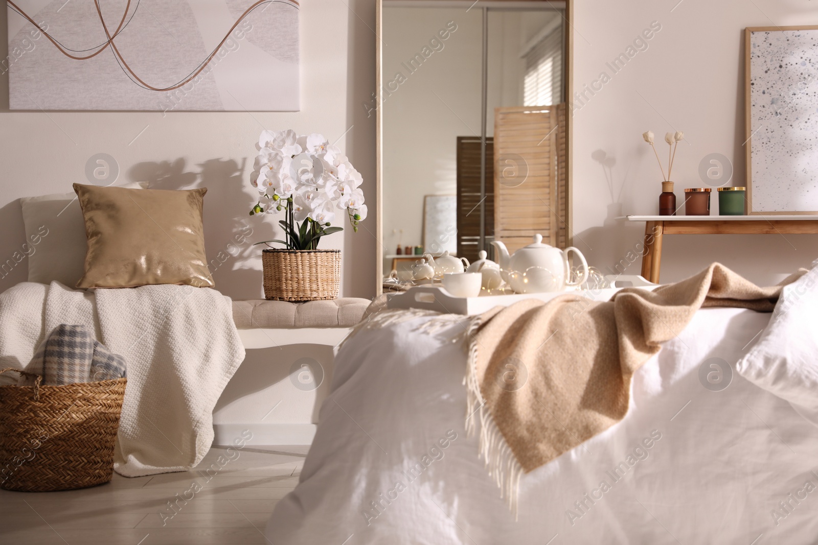 Photo of Beautiful bedroom interior with potted white orchids