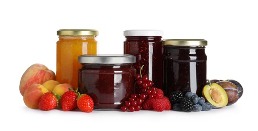 Jars with different jams and fresh fruits on white background