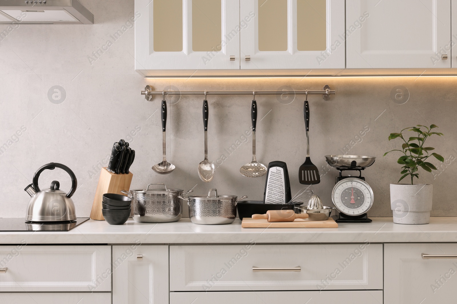 Photo of Set of different utensils on countertop in kitchen