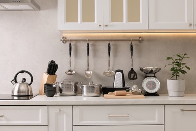 Set of different utensils on countertop in kitchen