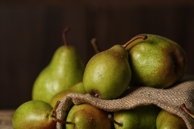 Photo of Fresh ripe pears against dark background, closeup view