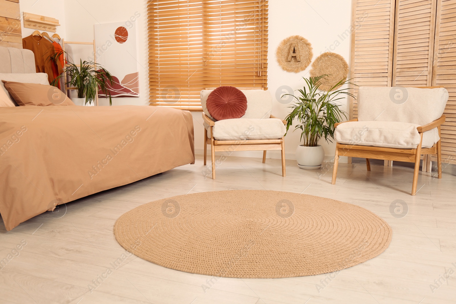 Photo of Bedroom interior with stylish furniture and straw rug