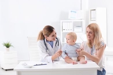 Photo of Woman with her baby visiting children's doctor in hospital