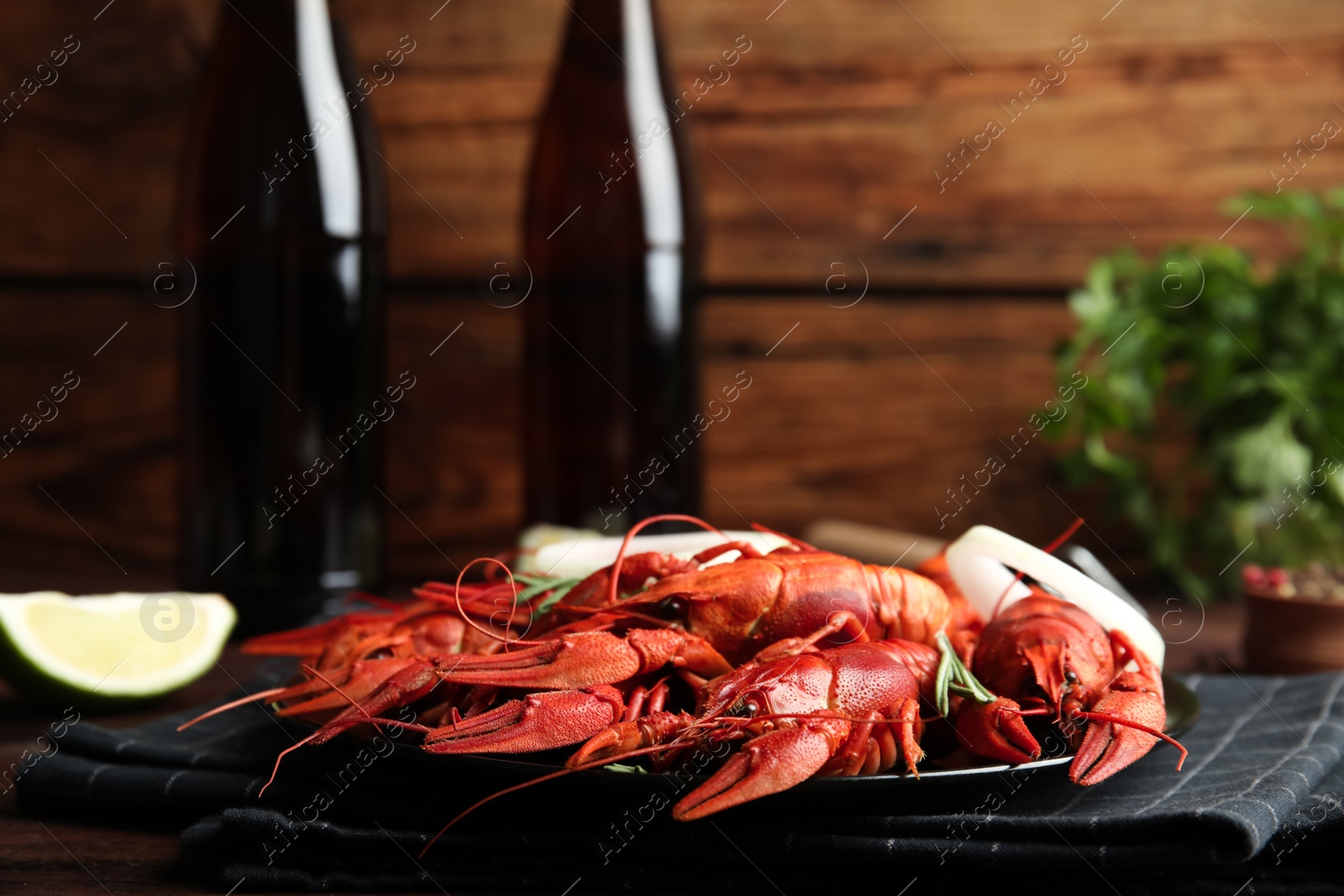 Photo of Delicious red boiled crayfishes on table, closeup