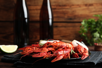 Photo of Delicious red boiled crayfishes on table, closeup