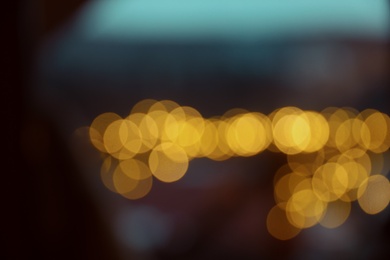 Blurred view of glowing lights on dark background